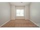 Bedroom with neutral paint and carpet; window allows natural light at 6007 Kenmore Ln, Indian Trail, NC 28079
