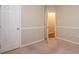 Clean bedroom featuring a door and decorative trim at 6007 Kenmore Ln, Indian Trail, NC 28079