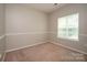 Cozy carpeted bedroom with a window offers natural light at 6007 Kenmore Ln, Indian Trail, NC 28079