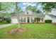 Charming single-Gathering home featuring a two-car garage and manicured front yard under a clear blue sky at 6007 Kenmore Ln, Indian Trail, NC 28079