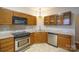 Kitchen features stainless steel appliances, granite countertops, and oak cabinets at 6007 Kenmore Ln, Indian Trail, NC 28079