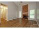 A bright living room featuring a fireplace and wood floors at 6007 Kenmore Ln, Indian Trail, NC 28079