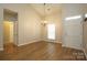 Bright living room featuring vaulted ceiling, wood floors, and chandelier lighting at 6007 Kenmore Ln, Indian Trail, NC 28079