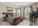 Bedroom features a wooden bed frame, an exercise machine, and patterned curtains at 6041 Laurent Ave, Fort Mill, SC 29715
