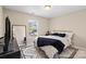 Cozy bedroom with a gold bed frame, geometric rug, and ample natural light at 6041 Laurent Ave, Fort Mill, SC 29715