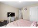 Bedroom with a pink comforter, desk area, and neutral color scheme at 6041 Laurent Ave, Fort Mill, SC 29715