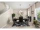 Dining area featuring a black table, chandelier, black chairs, and black & white rug at 6041 Laurent Ave, Fort Mill, SC 29715