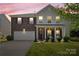 Charming two-story home featuring brick accents, a two car garage, and welcoming front porch at 6041 Laurent Ave, Fort Mill, SC 29715