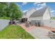 Spacious backyard with patio, grill area, firepit, and well-maintained lawn at 636 Sadler Glen Dr, Charlotte, NC 28214