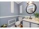 Stylish powder room with grey walls, white trim, framed wall decor, round mirror, and modern vanity at 636 Sadler Glen Dr, Charlotte, NC 28214