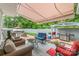 Outdoor patio with covered seating area, grill, and lush greenery at 636 Sadler Glen Dr, Charlotte, NC 28214