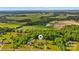 Scenic view of residential homes surrounded by lush greenery, mature trees, and open fields in a rural landscape at 6713 Edwards Farm Ln, Monroe, NC 28110