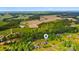 Beautiful property featuring a home, fenced yard, and outbuilding surrounded by lush greenery and expansive fields at 6713 Edwards Farm Ln, Monroe, NC 28110