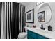 Stylish bathroom featuring modern fixtures, vanity, and striking black-and-white striped shower curtain at 6713 Edwards Farm Ln, Monroe, NC 28110