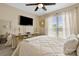 Inviting bedroom featuring neutral walls, a ceiling fan, and a decorative wall mirror at 6713 Edwards Farm Ln, Monroe, NC 28110