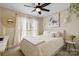 Comfortable bedroom with neutral decor, a ceiling fan, and a large window allowing for natural light at 6713 Edwards Farm Ln, Monroe, NC 28110