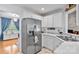 Updated kitchen featuring stainless steel appliances, white cabinets, and marble countertops at 6713 Edwards Farm Ln, Monroe, NC 28110