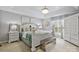 Spacious primary bedroom features neutral paint, tray ceilings, and a decorative chandelier at 6713 Edwards Farm Ln, Monroe, NC 28110
