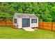 Backyard shed with ramp and shutters offers extra storage, complementing the fully fenced-in yard at 6713 Edwards Farm Ln, Monroe, NC 28110
