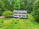 Picturesque aerial view of the home surrounded by lush greenery, offering privacy and a serene setting at 7531 Linda Lake Dr, Charlotte, NC 28215