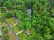 Aerial shot capturing a home nestled amidst lush greenery with a pond nearby at 7531 Linda Lake Dr, Charlotte, NC 28215