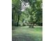 Peaceful backyard featuring a wooden picnic table and a wooded view at 7531 Linda Lake Dr, Charlotte, NC 28215