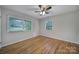 Bedroom with a ceiling fan, hardwood floors and two windows at 7531 Linda Lake Dr, Charlotte, NC 28215