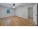 Bright bedroom features a ceiling fan, a window for natural light, and hardwood floors at 7531 Linda Lake Dr, Charlotte, NC 28215