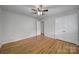 Bedroom featuring hardwood floors, a ceiling fan, and a double door closet at 7531 Linda Lake Dr, Charlotte, NC 28215