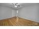 Bedroom with a ceiling fan, hardwood floors, neutral paint, closet and windows at 7531 Linda Lake Dr, Charlotte, NC 28215