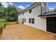 Large wooden deck outside of white brick house with access to backyard at 7531 Linda Lake Dr, Charlotte, NC 28215
