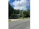 Classic two-story home surrounded by mature trees on a sunny day at 7531 Linda Lake Dr, Charlotte, NC 28215