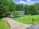 Charming two-story home with a long driveway and mature landscaping at 7531 Linda Lake Dr, Charlotte, NC 28215