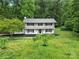 A charming two-story home with black shutters, a balcony and lush landscaping at 7531 Linda Lake Dr, Charlotte, NC 28215