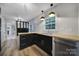 Kitchen boasts black cabinets, stainless steel appliances and a view to the adjacent rooms at 7531 Linda Lake Dr, Charlotte, NC 28215