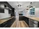 Modern kitchen featuring black cabinets, butcher block countertops, and stainless steel appliances at 7531 Linda Lake Dr, Charlotte, NC 28215