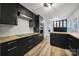 Sleek kitchen with black cabinets, wood countertops, and stainless steel appliances at 7531 Linda Lake Dr, Charlotte, NC 28215