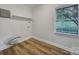 Bright laundry area with wood floors and a window providing natural light at 7531 Linda Lake Dr, Charlotte, NC 28215