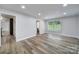 Open living room with hardwood floors, neutral paint, and large windows at 7531 Linda Lake Dr, Charlotte, NC 28215