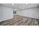 Bright living room features wood-look floors and natural light from a window at 7531 Linda Lake Dr, Charlotte, NC 28215