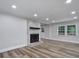Living room boasts freshly painted walls, fireplace, and wood flooring at 7531 Linda Lake Dr, Charlotte, NC 28215