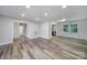 Open concept living area features wood-look flooring and many windows for natural light at 7531 Linda Lake Dr, Charlotte, NC 28215