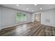 Bright living room features wood-look floors, recessed lighting and lots of natural light from large windows at 7531 Linda Lake Dr, Charlotte, NC 28215