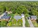 Aerial view of multiple homes with green lawns and many trees at 806 Mcgregor Ne Dr, Concord, NC 28025