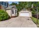 Backyard exterior featuring a detached garage with basketball hoop and attached home with bay window at 806 Mcgregor Ne Dr, Concord, NC 28025