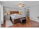 Comfortable bedroom with a large bed, hardwood floors, and ample lighting at 806 Mcgregor Ne Dr, Concord, NC 28025
