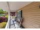 Cozy porch with a swing and rocking chair, offering a relaxing outdoor space at 806 Mcgregor Ne Dr, Concord, NC 28025