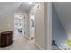 Hallway provides access to bedroom and bathroom with neutral paint and carpet leading to stairs at 806 Mcgregor Ne Dr, Concord, NC 28025