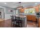 Well-lit kitchen with granite countertops, wooden cabinets, and a large island at 806 Mcgregor Ne Dr, Concord, NC 28025