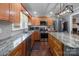 Spacious kitchen featuring granite countertops, stainless steel appliances, and hardwood floors at 806 Mcgregor Ne Dr, Concord, NC 28025